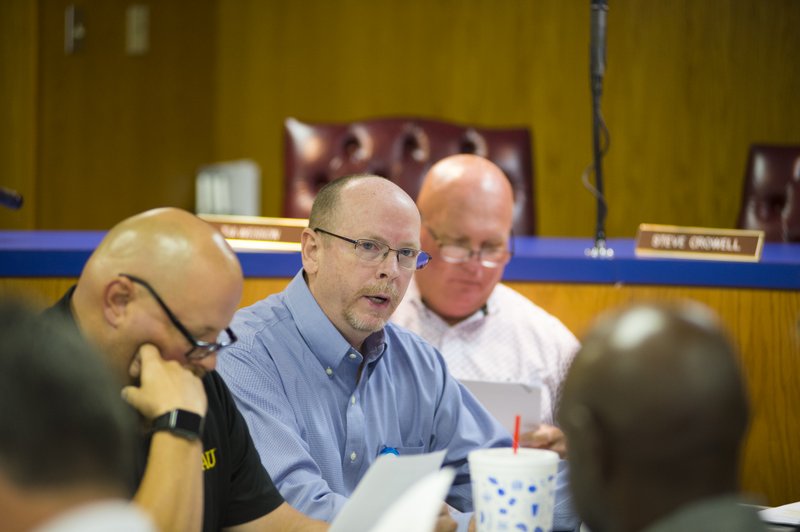 Rex Jones (center), Magnolia Regional Medical Center chief executive officer, elaborates on the potential hazards and possible financial pitfalls ahead of the hospital, should three government officials permanently sit on a newly-formed MRMC nonprofit hospital’s board of commissioners.
