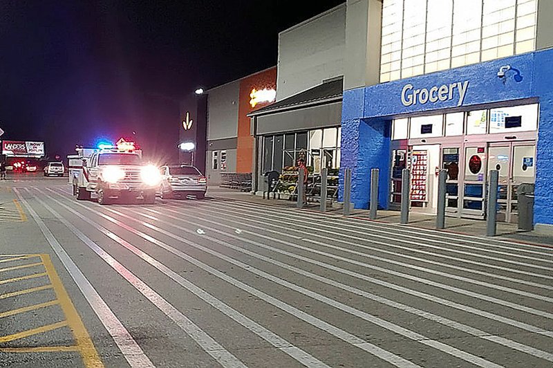 COURTESY PHOTO BY NICOLE RIDLEN/Law enforcement secured the perimeter of the Walmart premises while the building was being searched. A fire engine and ambulance were also on-site.