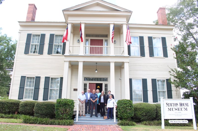 Museum: Members of the Arkansas History Commission pose in front of the Newton House Museum. The Commission held their quarterly meeting in El Dorado yesterday, taking in the South Arkansas Historic Preservation Society’s Gallery of History and Newton House Museum. Pictured from left to right are Robert McCarley, Jimmy Bryant, Ron Fuller, Elizabeth Eggleston, Julienne Crawford, Jason Hendren and Diane Alderson. Caitlan Butler / News-Times