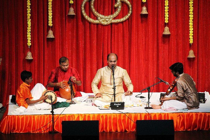 Siddharth Sridharan (left), 11, plays the mridangam in the Indian performance debut known as an arangetram, accompanying ghatam player Adambakkam Shankar; vocalist Delhi Sunderrajan; and violinist Vignesh Thyagarajan on Sept. 7. 