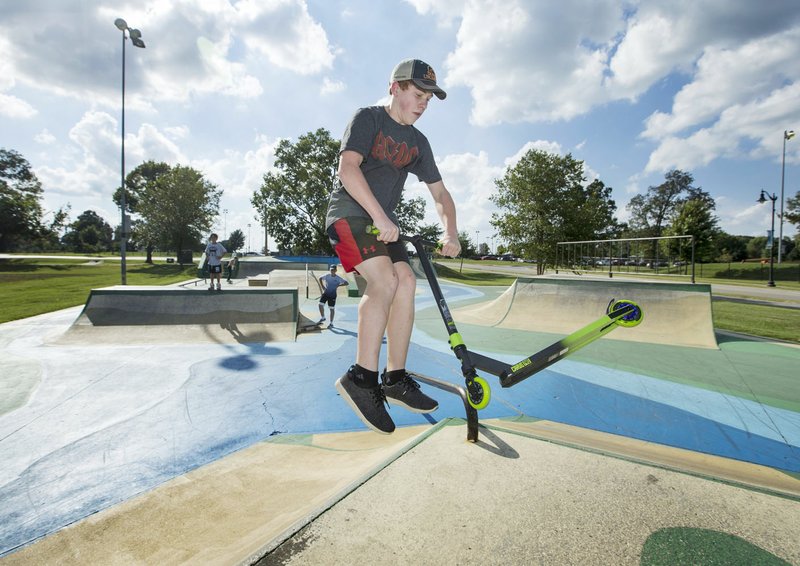 NWA Democrat-Gazette/BEN GOFF &#8226; @NWABENGOFF Vedder Lee, 14, of Bentonville, practices Thursday tricks on his scooter at the Memorial Park skate park in Bentonville.