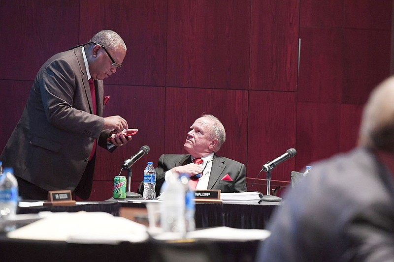 University of Arkansas system trustees Mark Waldrip (right) and Stephen Broughton visit at the board of trustees meeting in Fayetteville in this Thursday, Sept. 12, 2019, file photo. (NWA Democrat-Gazette/J.T. Wampler)