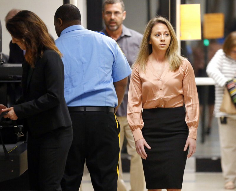 Fired Dallas police Officer Amber Guyger, right, arrives for jury selection in her murder trial at the Frank Crowley Courthouse in downtown Dallas, Friday, Sept. 13, 2019. Guyger shot and killing Botham Jean, an unarmed man in his own apartment last year. (Tom Fox/The Dallas Morning News via AP)