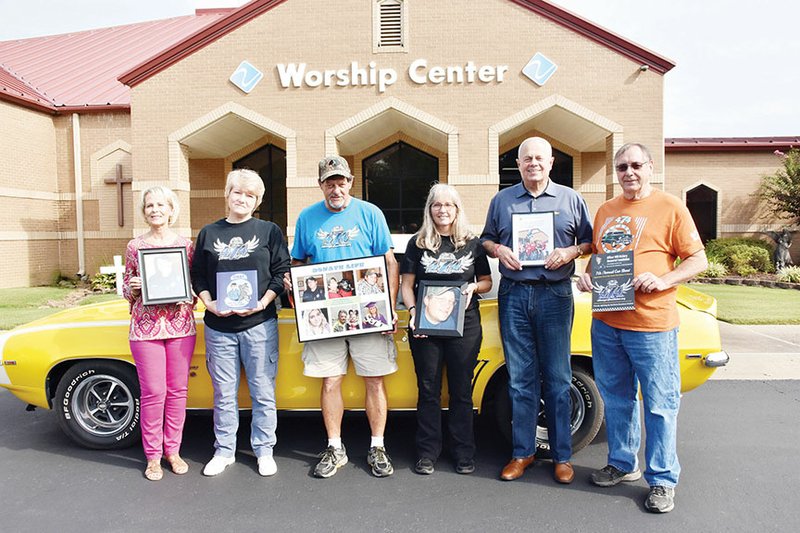 Getting ready for the seventh annual Officer Will McGary Memorial Car Show in Searcy are, from left, Gail Hodges, Valley Baptist Church member; Robbi Casey, family friend and board member of the Officer Will McGary Memorial Foundation; the late Will McGary’s parents, Harold and Tanya McGary of Searcy; James Hays, board member and pastor of the church; and Jim Pinner, church member and car show founder. Will’s sister, Lindsey Montambault of Searcy (not pictured), is on the foundation board, too, and helps with the car show. The car is Pinner’s 1969 Camaro SS convertible. The car show is set for Sept. 28 at Get Down Downtown in Searcy. Will McGary was a Conway police officer.
