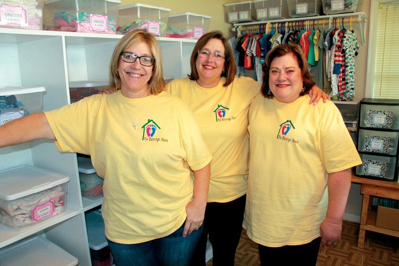 Mary Kay Palmer, from left, Marla Moore, and Nancy Watson stand inside the new Blessings House Pregnancy Support Center in Sheridan. The center offers services to expectant moms and parents with babies from birth to 24 months. “We want to show Christ’s love to moms, dads and babies of the Grant County area,” Palmer said.