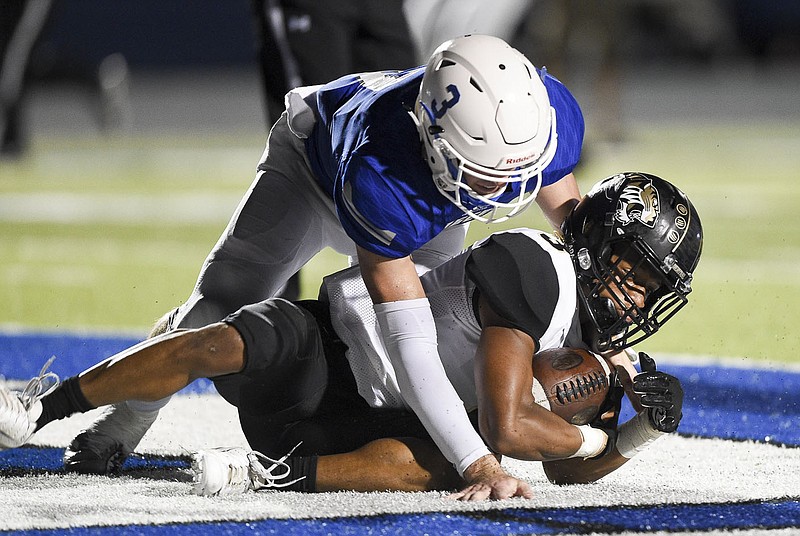 NWA Democrat-Gazette/CHARLIE KAIJO Little Rock Central wide receiver Antoine Westbrook (3) scores as Rogers High School quarterback Hunter Loyd (3) blocks during a football game, Friday, September 13, 2019 at Rogers High School in Rogers.