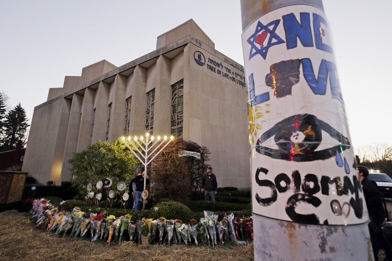  This Dec. 2, 2018, file photo shows a menorah at a memorial outside the Tree of Life Synagogue, where Robert Bowers killed worshippers in an Oct. 27 shooting, as people prepare for a celebration service at sundown on the first night of Hanukkah in the Squirrel Hill neighborhood of Pittsburgh. A federal judge on Friday, Sept. 13, 2019 ordered the immediate release of a man whose relatives reported concerns about his behavior and far-right extremist rhetoric after last year's Pittsburgh synagogue massacre.  (AP Photo/Gene J. Puskar, File)