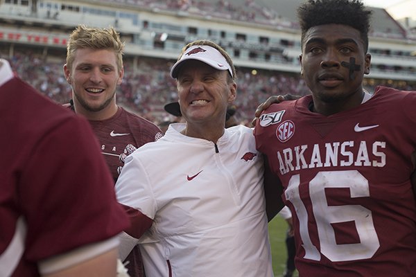Arkansas coach Chad Morris (center) celebrates with receiver Treylon Burks (right) following the Razorbacks' 55-34 victory over Colorado State on Saturday, Sept. 14, 2019, in Fayetteville. 
