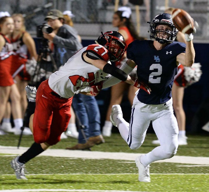 Springdale Har-Ber receiver Hunter Wood (2) reaches for an overthrown pass while Russellville defensive back Caleb Gray defends in the Wildcats’ 49-0 victory at Wildcat Stadium in Springdale. For more photos, go to arkansasonline.com/914russellville. 