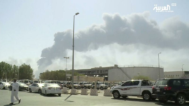 Smoke from the Abqaiq oil processing facility fills the sky Saturday in Buqayq, Saudi Arabia. 