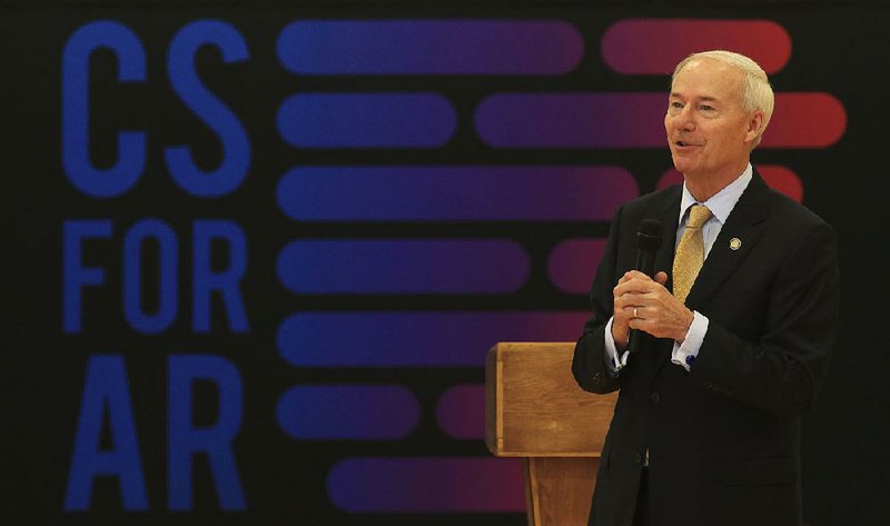 Gov. Asa Hutchinson talks to students during a stop Thursday at Sylvan Hills Middle School in Sherwood. Hutchinson says he continues to hear stories that affirm his commitment to computer education. 