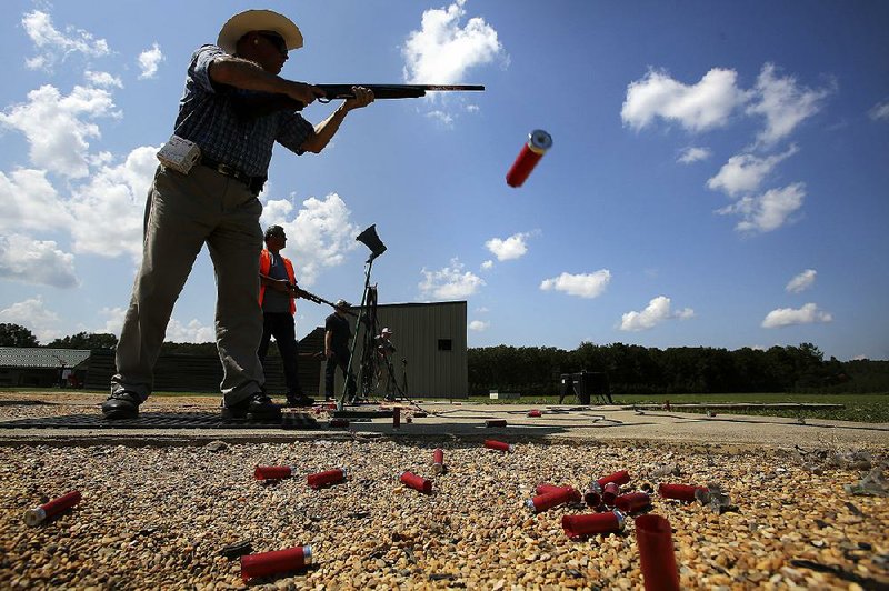 In this photo James Miller of Little Rock watches his shot while competing at the Arkansas Game and Fish Trap Shooting Complex in Jacksonville. 
