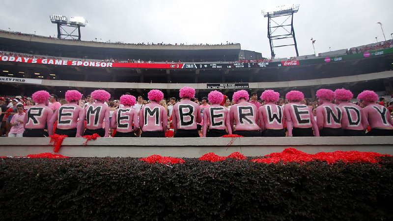 Georgia students observe a moment of silence in honor of Wendy Anderson, the wife of Arkansas State Coach Blake Anderson, before the game between the Bulldogs and Red Wolves on Saturday at Athens, Ga. Wendy Anderson died in August after a battle with breast cancer. See more photos at arkansasonline.com/915pinkout.