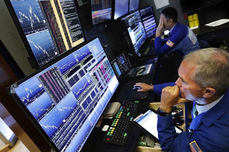 Trader Timothy Nick (foreground) works on the floor of the New York Stock Exchange. 