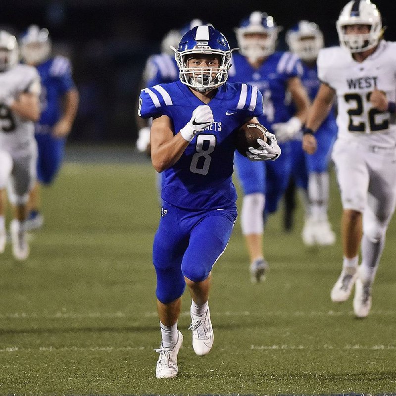 Bryant receiver Jake Meaders runs away from Bentonville West free safety Maddox Thornton for a touchdown Friday at Hornet Stadium in Bryant. Bryant won 38-0. For more photos, go to arkansasonline.com/914bentonville/. 