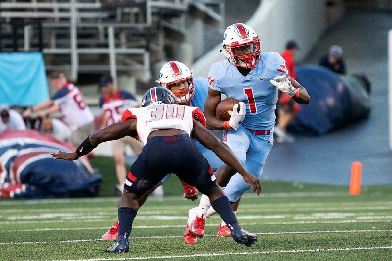 Little Rock Parkview running back James Jointer (1) tries to run past Marion linebacker Antonio Grays during the first quarter of Parkview’s 28-24 victory on Friday at War Memorial Stadium in Little Rock. For more photos, go to arkansasonline.com/914marion/.