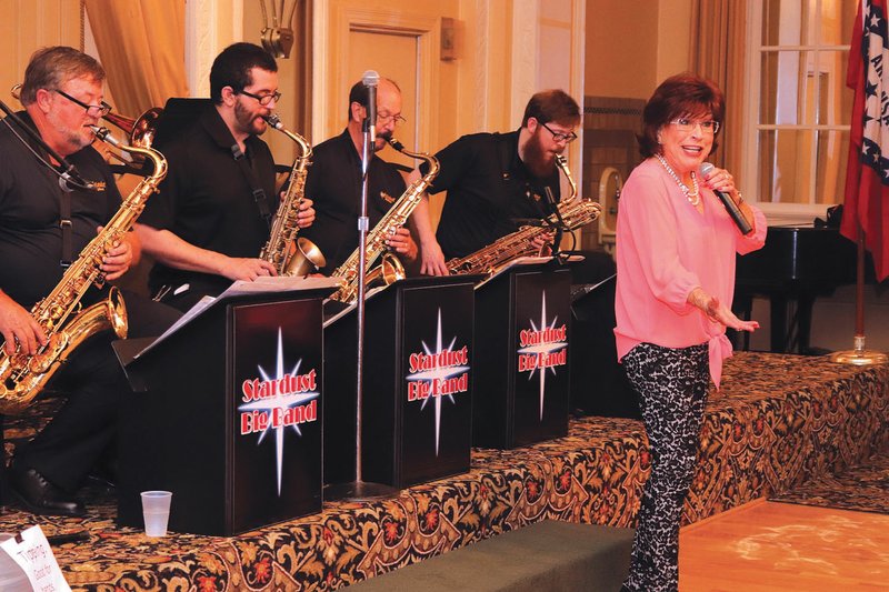 Arkansas Democrat-Gazette/HELAINE R. WILLIAMS Shirley Chauvin of Hot Springs sings to the accompaniment of the Stardust Big Band at its monthly performance July 28 in the ballroom of the Arlington Resort Hotel & Spa in Hot Springs. The band, organized by area high school band directors 37 years ago, plays at the hotel once a month and every New Year's Eve.