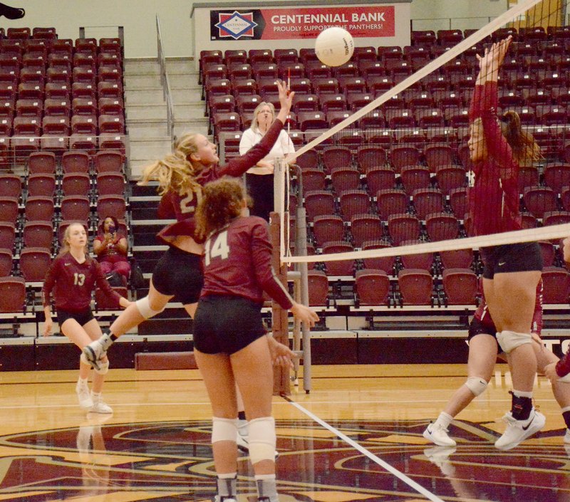 Graham Thomas/Siloam Sunday Siloam Springs senior Abby Herring, No. 21, goes up for a tip over the Beebe block during Tuesday's match inside Panther Activity Center. The Lady Badgers swept the Lady Panthers 3-0.