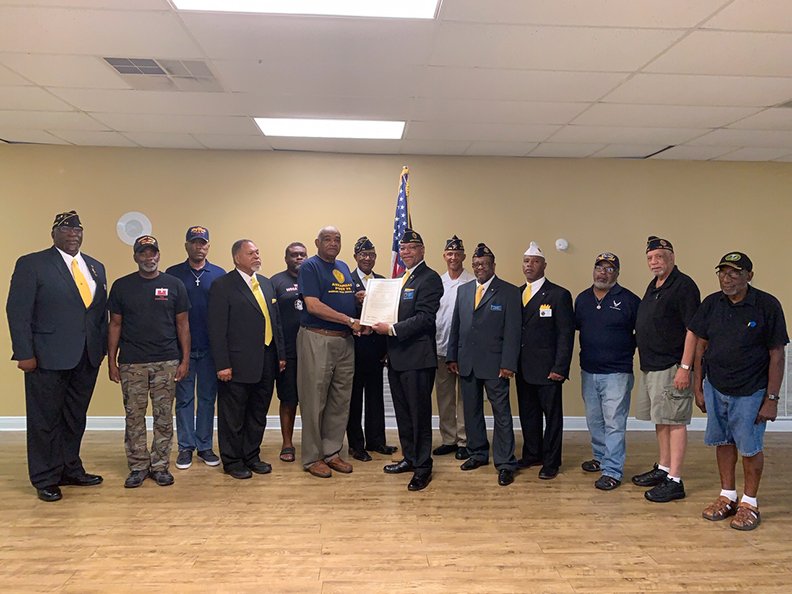 Submitted photo NEW POST: U.S. Army veteran Curtis Craft, center left, receives the charter for the new American Legion Post 2020, from R.D. Kinsey, the outgoing state commander of the American Legion of Arkansas, at the Post's last meeting on Aug. 18 at the Webb Community Center. The Post, which is looking for members, will have it's next meeting at the center on Sept. 28.