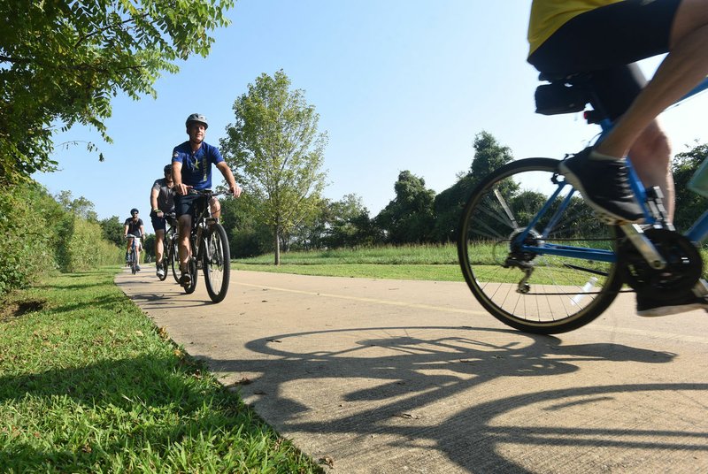 NWA Democrat-Gazette/FLIP PUTTHOFF Riders in Rogers head south Sept. 7 along the Razorback Greenway during the Square to Square bicycle ride from Bentonville to Fayetteville.