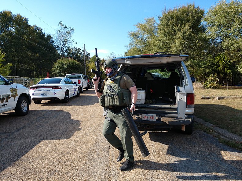 An unidentified officer in tactical gear joins the Garland County Sheriff's Department search for a suspect in a stabbing who eluded capture Saturday evening in the 100 block of Trace Court. - Photo by Tanner Newton of The Sentinel-Record