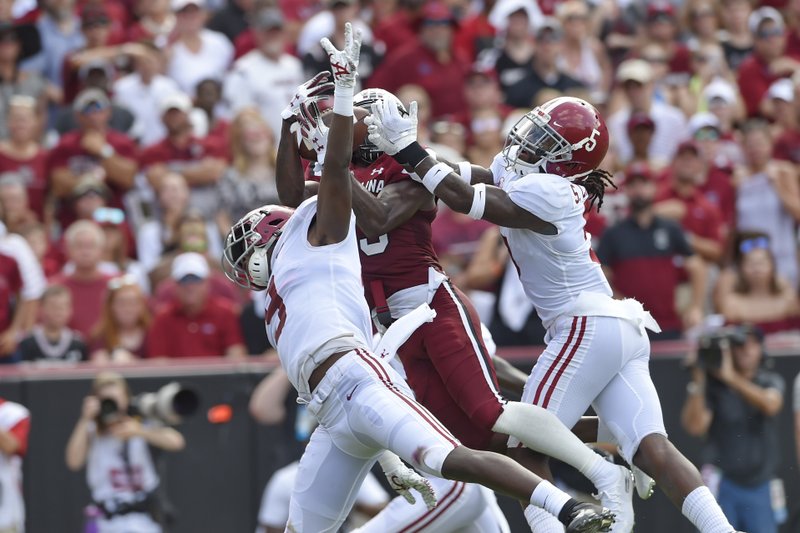South Carolina's Shi Smith, center, catches a touchdown pass while defended by Alabama's Jordan Battle, left, and Shyheim Carter during the first half of an NCAA college football game Saturday, Sept. 14, 2019, in Columbia, S.C. (AP Photo/Richard Shiro)