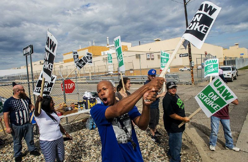 Jashanti Walker, a first-shift team leader at a General Motors assembly plant in Flint, Mich., demonstrates Sunday with other employees outside the plant.