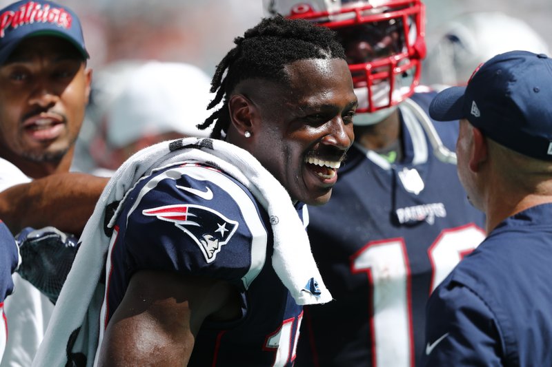 New England Patriots wide receiver Antonio Brown (17) smiles on the sidelines, during the second half at an NFL football game against the Miami Dolphins, Sunday, Sept. 15, 2019, in Miami Gardens, Fla. (AP Photo/Brynn Anderson)