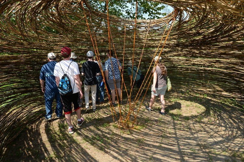 NWA Democrat-Gazette/ANDY SHUPE Visitors check out a bird blind Saturday constructed by Fayetteville artist Stuart Fulbright during a tour of the Wilson Springs Preserve in Fayetteville. The Northwest Arkansas Land Trust has been working for seven years to preserve and restore the 121-acre prairie wetland.