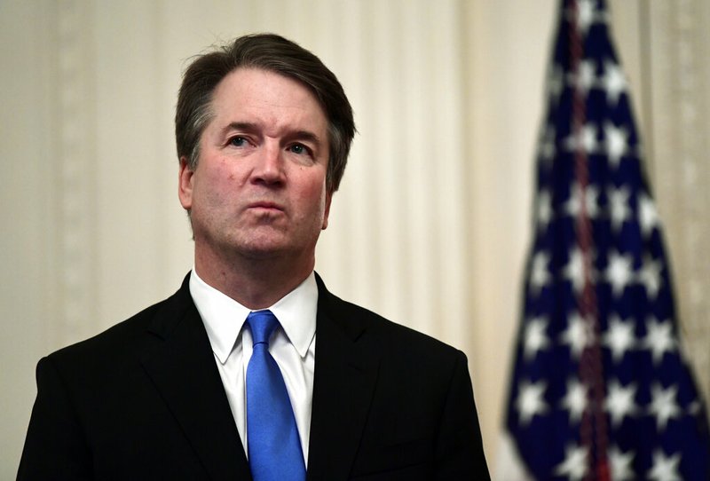 FILE - In this Oct. 8, 2018, file photo, Supreme Court Justice Brett Kavanaugh stands before a ceremonial swearing-in in the East Room of the White House in Washington. At least two Democratic presidential candidates, Kamala Harris and Kamala Harris are calling for the impeachment of Supreme Court Justice Brett Kavanaugh in the face of a new, uninvestigated, allegation of sexual impropriety when he was in college. (AP Photo/Susan Walsh, File)