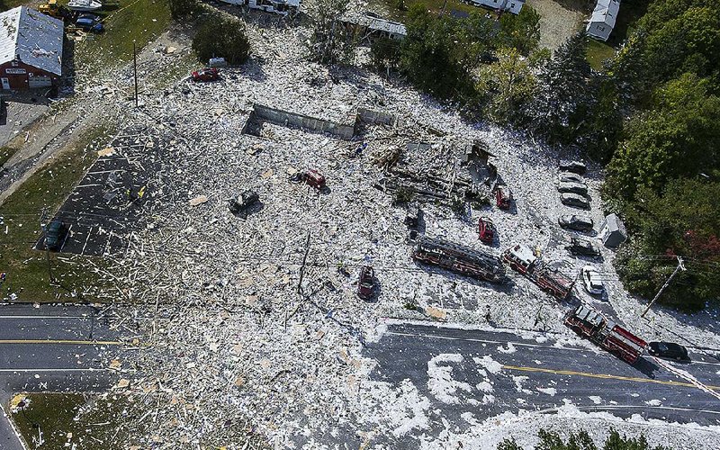 Debris lies scattered across a wide area in Farmington, Maine, after a propane explosion that flattened a newly constructed two-story building. The explosion occurred after firefighters arrived to investigate reports that the smell of gas had been detected at the site. A firefighter was killed and eight people were injured in the blast. 