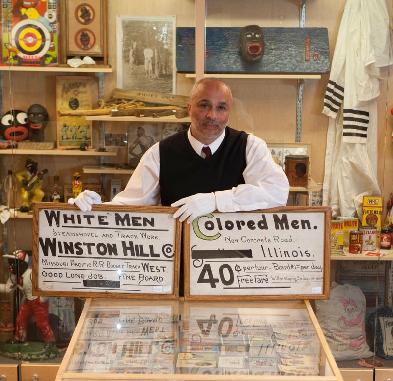 David Pilgrim, founder of the Jim Crow Museum in Michigan, shows off some of his collection of racist memorabilia. A traveling tour of memorabilia opens Thursday at the Mosaic Templars Cultural Center in Little Rock. (Special to the Democrat-Gazette)