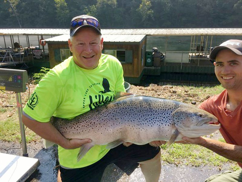 Courtesy photo Bill Babler (left) of Blue Eye, Mo. and his friend, Ryan Titus show the 40-pound, 6-ounce brown trout Babler caught at Lake Taneycomo to set a new Missouri brown trout record.