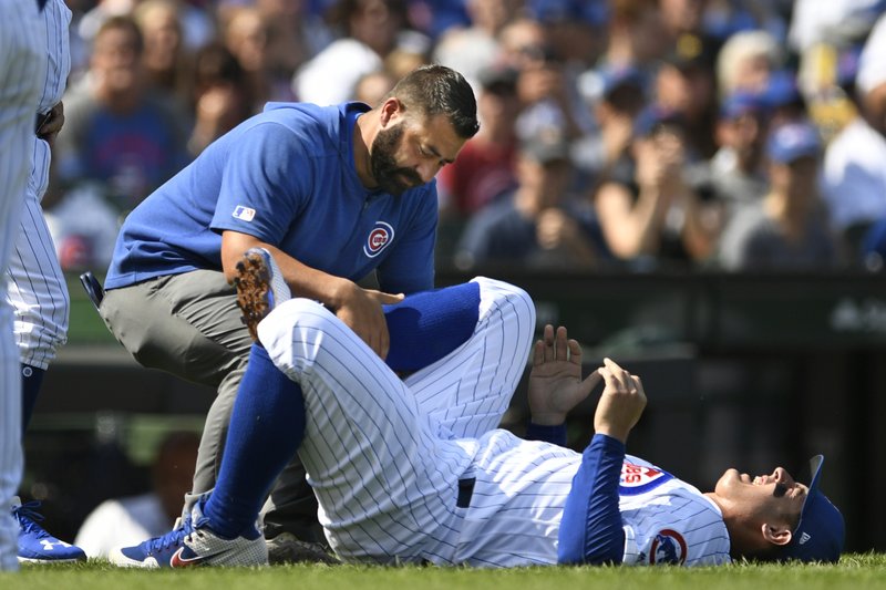The Associated Press ANKLE INJURY: Chicago Cubs' Anthony Rizzo is tended to after spraining his ankle during the third inning of Sunday's game against the Pittsburgh Pirates in Chicago.