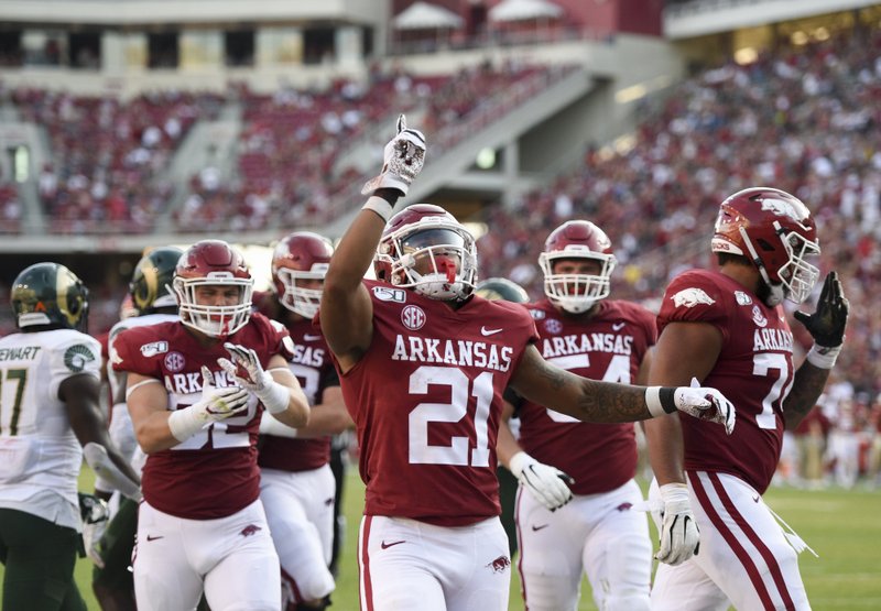 RUSHING TO CHEER: Arkansas Razorbacks running back Devwah Whaley (21) reacts after scoring a touchdown during the third quarter of Saturday's game at Donald W. Reynolds Razorback Stadium in Fayetteville.