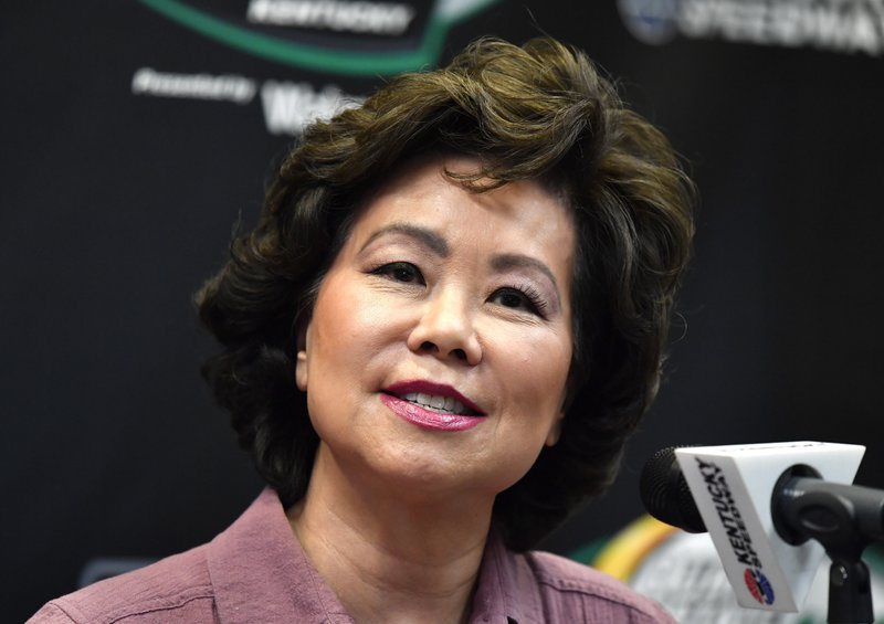 FILE - In this July 13, 2019, file photo, Transportation Secretary Elaine Chao addresses the media before the NASCAR series auto race at Kentucky Speedway in Sparta, Ky. The House Oversight Committee says it is investigating whether Chao acted improperly to benefit herself or her family&#x2019;s shipping company. (AP Photo/Timothy D. Easley, File)