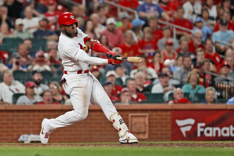 The Associated Press DOUBLE UP: St. Louis Cardinals' Marcell Ozuna hits a ground-rule double to score two runs during the seventh inning of Monday's game against the Washington Nationals in St. Louis.