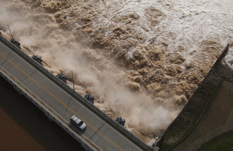 In this May 24, 2019 file photo, water is released from the Keystone Dam into the Arkansas River northwest of Tulsa, Okla., The U.S. Army Corps of Engineers has proposed a $160 million plan to shore up the 75-year-old Tulsa-West Tulsa Levee System, a system of levees and pumping stations around Oklahoma's second largest city that has been weakened by periodic flooding. (Tom Gilbert/Tulsa World via AP, File)