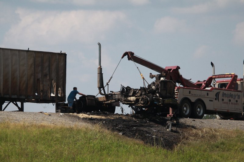 Workers shift the remains of a tractor-trailer following a crash on Interstate 530 in Pine Bluff.