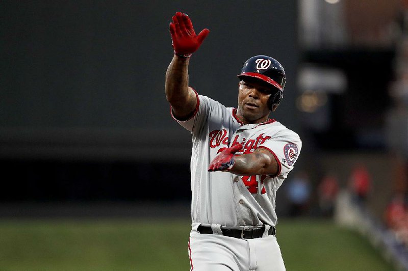 Howie Kendrick of the Washington Nationals gestures toward the dugout after hitting a triple in the second inning of the Nationals’ victory over the St. Louis Cardinals on Tuesday night in St. Louis. Kendrick had three hits, including a home run. 