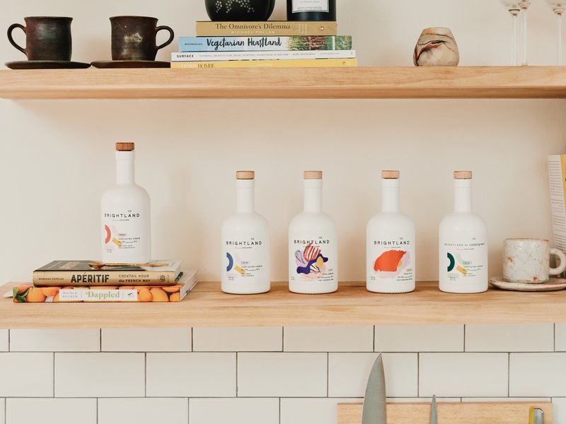 Bottles of Brightland oils, made from California olives and labeled with the month and date of harvest, in the Los Angeles home of Aishwarya Iyer, the founder of Brightland. Photo by Adam Amengual (The New York Times)