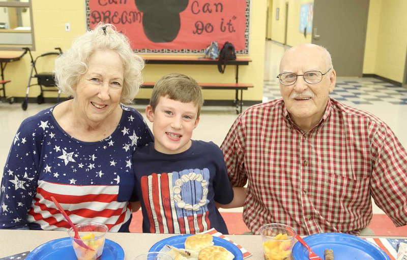 Clarence Wiles and his wife, Sue, of West Fork, eat breakfast with their grandson, Caleb, 8, a second grader at Williams Elementary in Farmington. The school hosted a Salute to Heroes in memory of 9-11 and to honor first responders, active and retired military. Clarence Wiles served in the U.S Army from 1961 to 1964.
