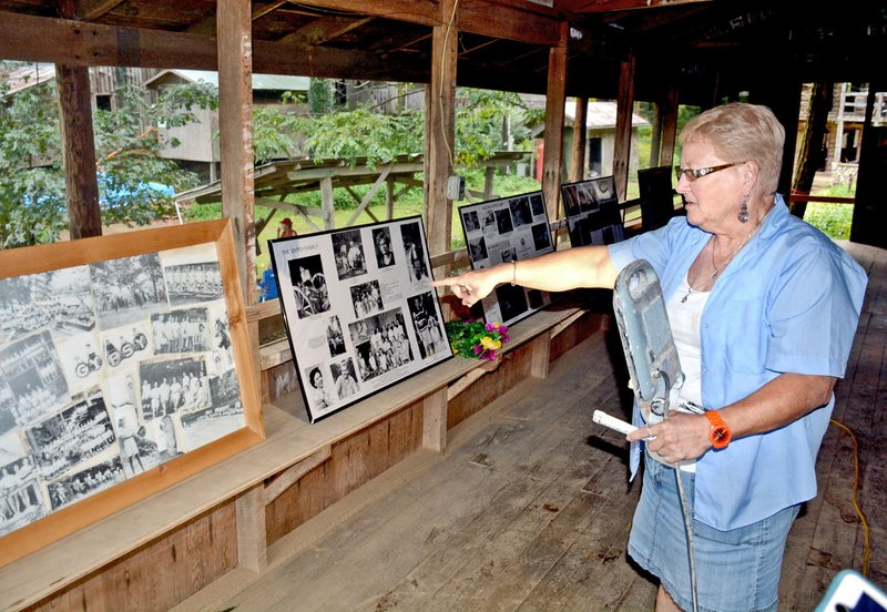 Janelle Jessen/Herald-Leader Jo Patrick of Bella Vista points to old photos of the Gypsy Camp during a tour of the historic camp on Friday.