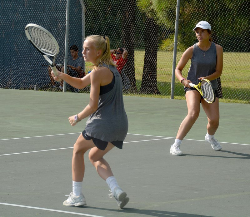 Graham Thomas/Herald-Leader The Siloam Springs doubles team of Eve Slater (left) and Ohla Los compete against Greenwood in a 5A-West Conference match Monday at the John Brown University Tennis Complex.