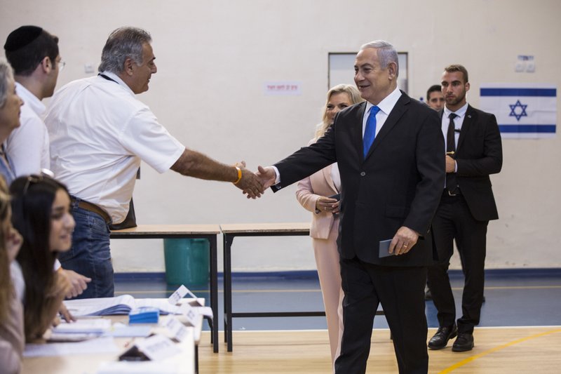 Israeli Prime Minister Benjamin and his wife Sarah arrive at a voting station in Jerusalem on September 17, 2019. Israelis began voting Tuesday in an unprecedented repeat election that will decide whether longtime Prime Minister Benjamin Netanyahu stays in power despite a looming indictment on corruption charges. (Heidi Levine, Sipa, Pool via AP).