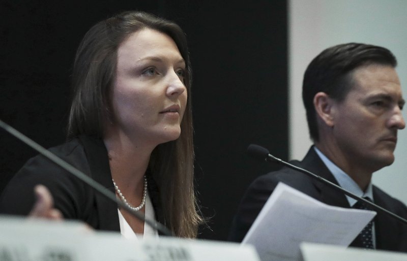 FILE - In this July 16, 2019 file photo, Courtney Wild, left, joined by her attorney Brad Edwards, reads a statement during a news conference in New York calling on victims of Jeffrey Epstein to contact the FBI or lawyers with their information. Epstein's accusers have suffered a setback in seeking money from the government over a plea deal that spared the financier a lengthy prison term. U.S. District Judge Kenneth Marra ruled on Monday, Sept. 16, 2019 that the government doesn't owe them money for it. (AP Photo/Bebeto Matthews, File)