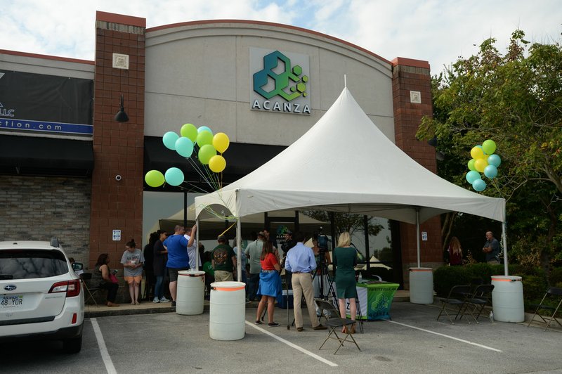 File Photo/NWA Democrat-Gazette/ANDY SHUPE Residents wait in line Saturday at Acanza, the first medical marijuana dispensary in Fayetteville, opens for the first time.