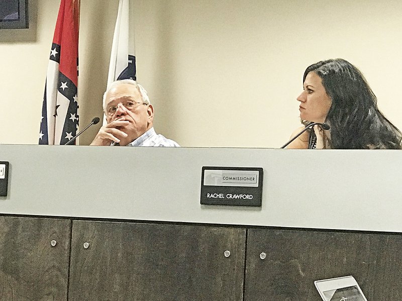NWA Democrat-Gazette/ALEX GOLDEN Planning Commissioners Don Spann and Rachel Crawford consider items Tuesday at a commission meeting in Rogers.