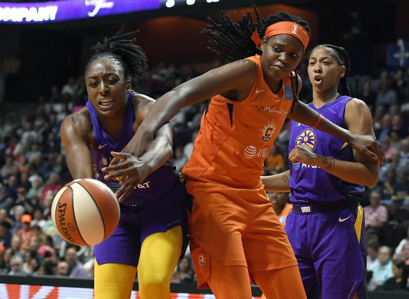 The Associated Press BALL BATTLE: Los Angeles Sparks' Nneka Ogwumike, left, and Connecticut Sun's Jonquel Jones reach for a loose ball as Los Angeles Sparks' Candace Parker, right, defends during the first half of Tuesday's game in Uncasville, Conn.