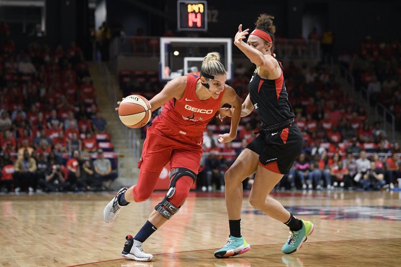 The Associated Press DRIVER'S Seat Washington Mystics forward Elena Delle Donne, left, drives to the basket against Las Vegas Aces forward Dearica Hamby during the first half of Tuesday's playoff game in Washington.